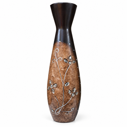 A tall, narrow decorative vase with a dark brown glossy top section and a textured brown lower section featuring silver floral vine and leaf designs, set against a plain white background.