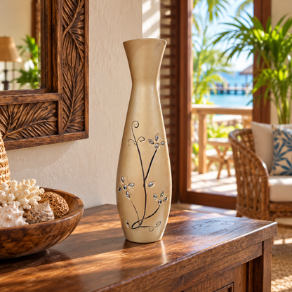 A tall, slender ceramic vase with a beige finish and delicate black floral vine patterns, displayed on a wooden console table in a tropical resort setting.